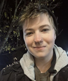 Photo of Ashten Vassar wearing a beanie and black jacket, while smiling